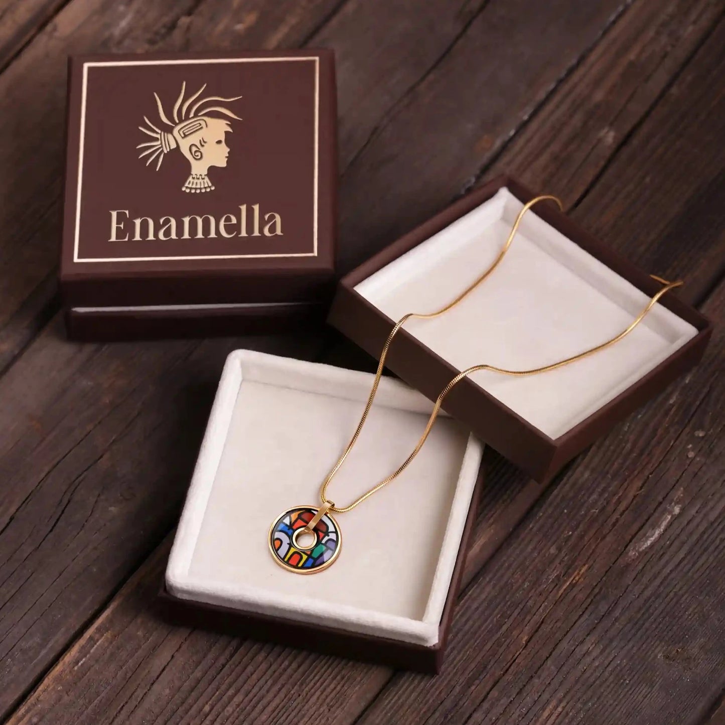 Yellow gold round necklace with the painting of Friedensreich Hundertwasser's "Spanish Nights". The necklace is placed inside a square box